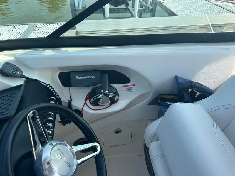 Slide: The Image of Interior of 2015 Sea Ray 300 SLX boat with steering wheel and Raymarine equipment. - 15