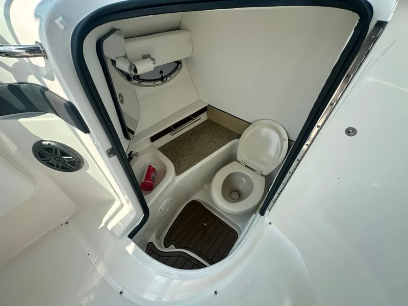 Slide: The Image of 2015 Sea Ray 300 SLX boat interior with compact bathroom and toilet. - 20