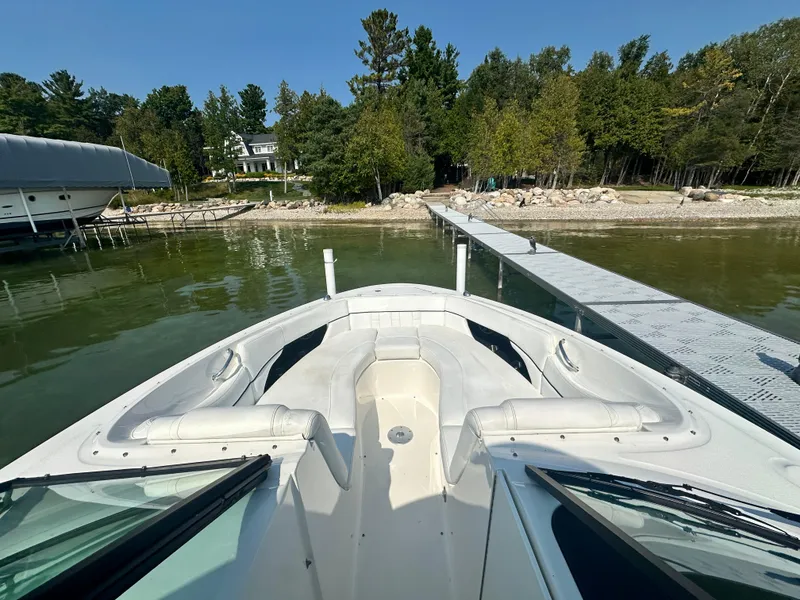Slide: The Image of 2015 Sea Ray 300 SLX boat docked by a scenic lakeside with trees. - 21