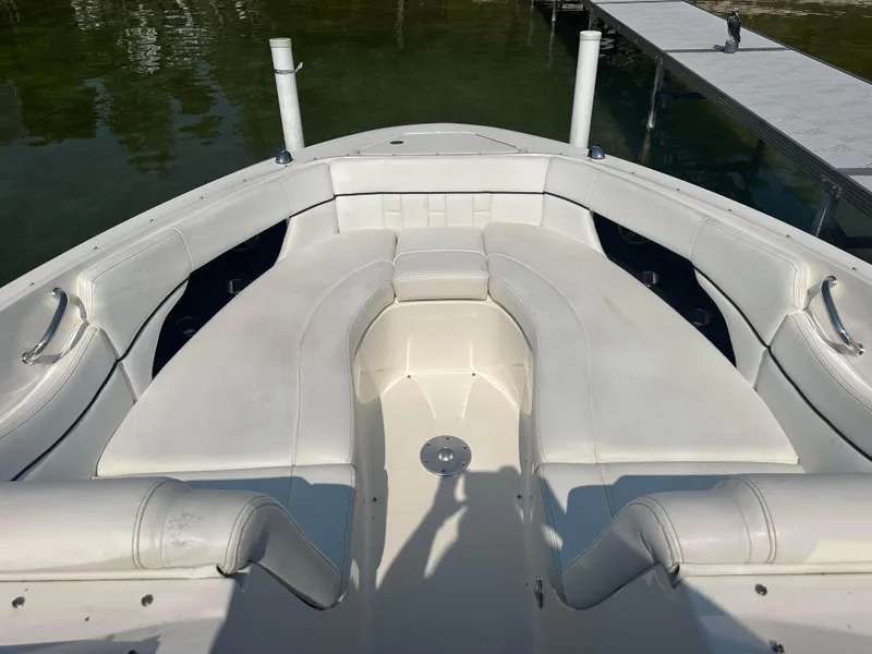 Slide: The Image of 2015 Sea Ray 300 SLX boat interior with white seating and dock view. - 23