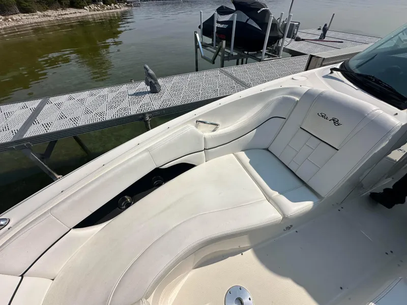 Slide: The Image of 2015 Sea Ray 300 SLX boat with white seating, docked by the water. - 24