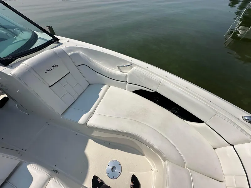 Slide: The Image of 2015 Sea Ray 300 SLX boat interior with white seating and calm water backdrop. - 26