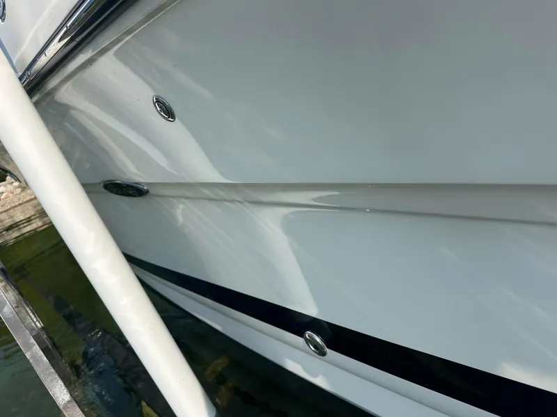 Slide: The Image of 2015 Sea Ray 300 SLX boat hull, sleek white design with chrome accents. - 3