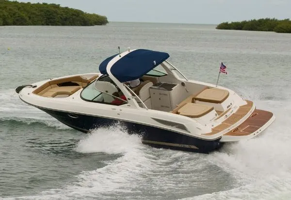 Slide: The Image of 2015 Sea Ray 300 SLX cruising on water with American flag, featuring sleek design and spacious seating. - 33