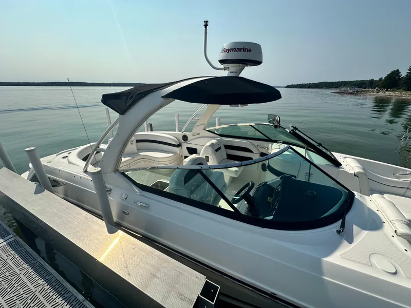 Slide: The Image of 2015 Sea Ray 300 SLX boat docked on calm water. - 5
