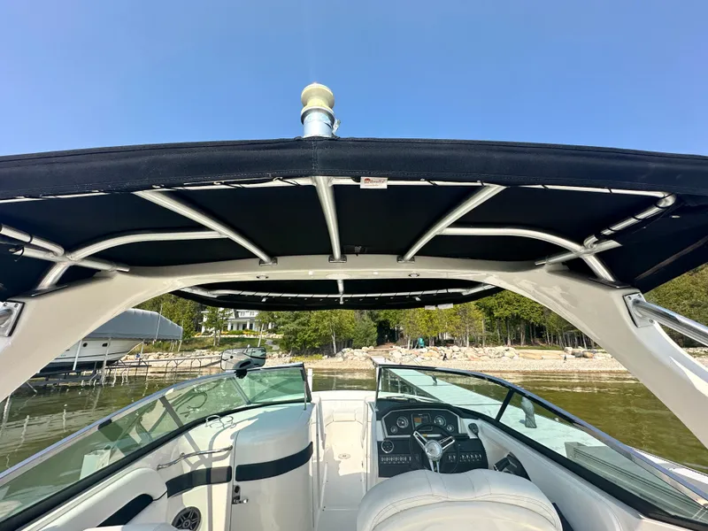 Slide: The Image of 2015 Sea Ray 300 SLX boat interior with canopy, steering wheel, and dashboard. - 7