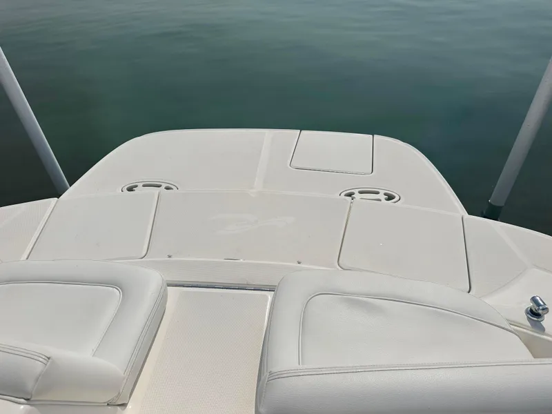Slide: The Image of 2015 Sea Ray 300 SLX boat deck with white seating and calm water backdrop. - 8
