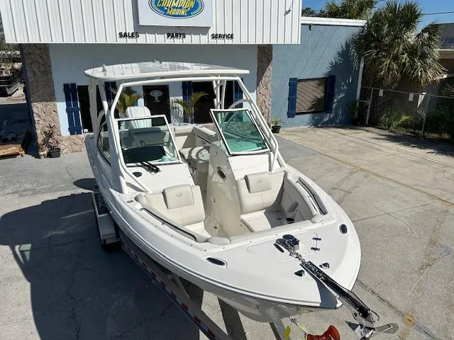 Slide: The Image of 2025 Sailfish 245 DC boat displayed at a dealership, showcasing sleek design and spacious seating. - 14