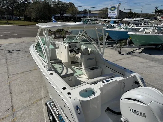Slide: The Image of 2025 Sailfish 245 DC boat with Yamaha engine, docked outdoors on a sunny day. - 15