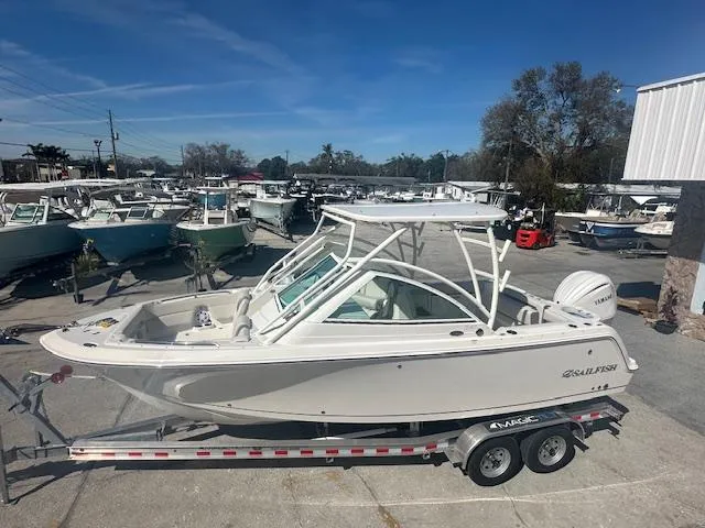 Slide: The Image of 2025 Sailfish 245 DC boat on trailer in marina setting. - 16