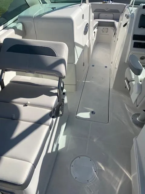 Slide: The Image of 2025 Sailfish 245 DC boat interior with seating and control panel. - 2