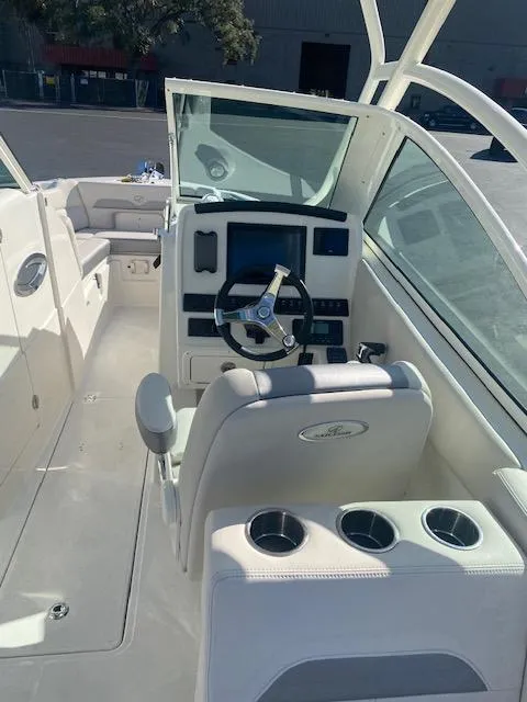 Slide: The Image of 2025 Sailfish 245 DC boat interior with modern dashboard and seating. - 3