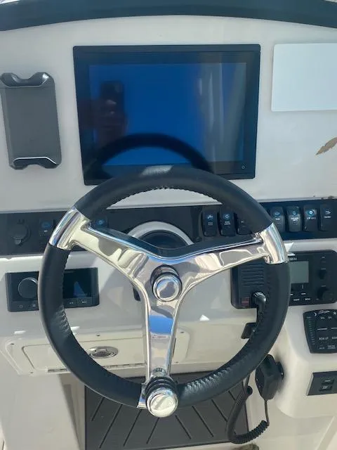 Slide: The Image of Steering wheel and dashboard of 2025 Sailfish 245 DC boat. - 6