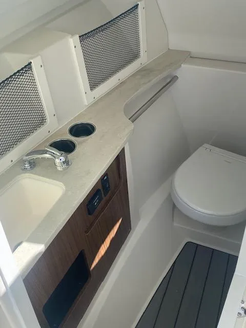 Slide: The Image of 2025 Sailfish 245 DC boat interior with sink and toilet. - 8