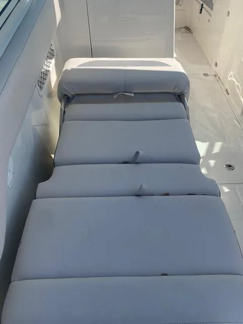 Slide: The Image of 2025 Sailfish 245 DC boat interior with cushioned seating. - 9