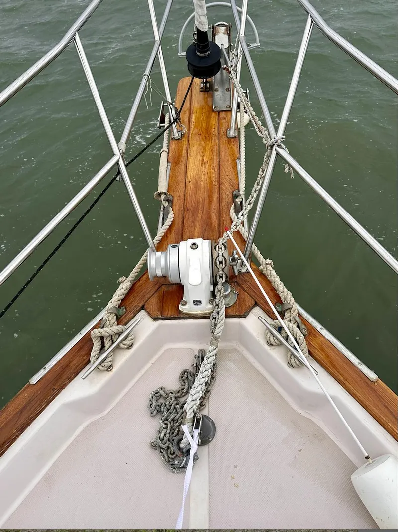 Slide: The Image of Bow of 1987 Island Packet 31 sailboat with anchor chain and teak deck. - 2