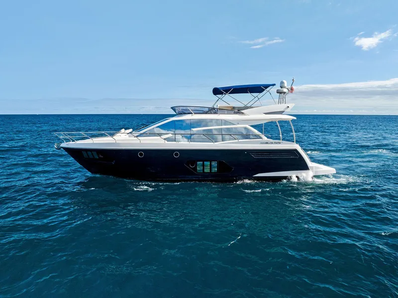 The Image of Luxury yacht Absolute 55 FLY 2013 cruising on open sea under clear blue sky. - 0