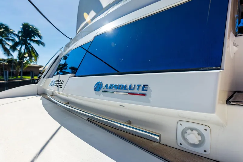 Slide: The Image of 2013 Absolute 55 FLY yacht with sleek design and reflective windows. - 21