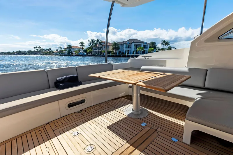 Slide: The Image of Luxurious 2013 Absolute 55 FLY yacht deck with seating and table, overlooking waterfront homes. - 26