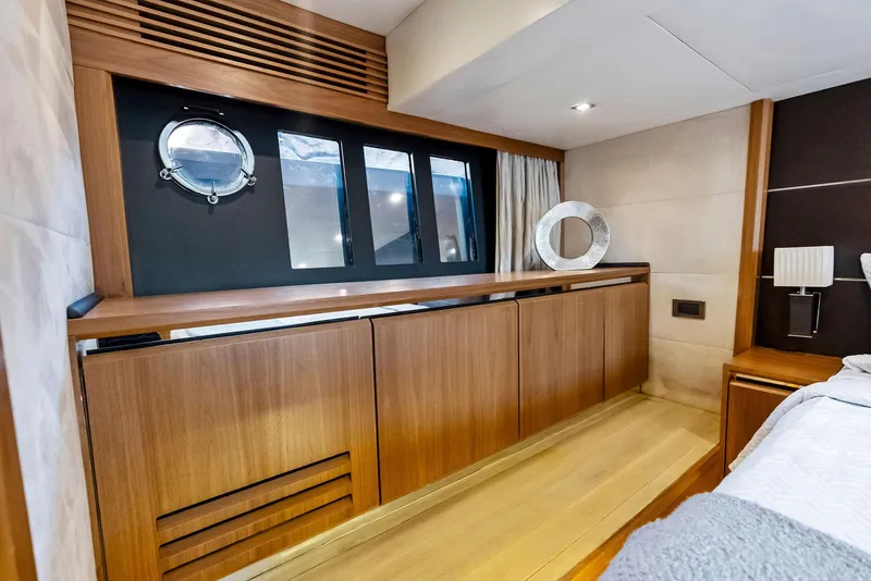 Slide: The Image of Luxurious interior of 2013 Absolute 55 FLY yacht with wooden cabinetry and porthole window. - 48
