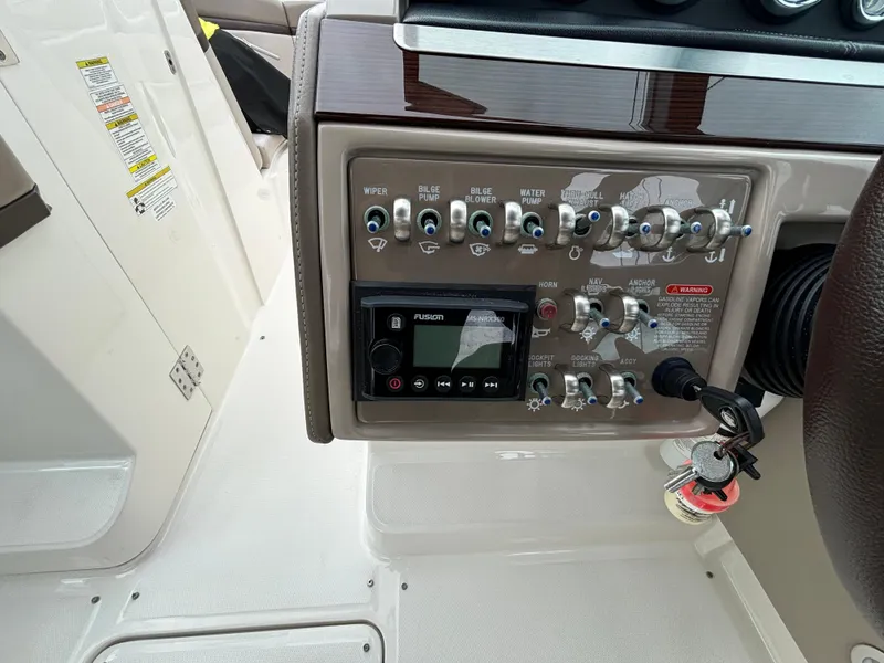 Slide: The Image of Control panel of a 2013 Sea Ray 270 SLX boat with switches and a Fusion stereo. - 13
