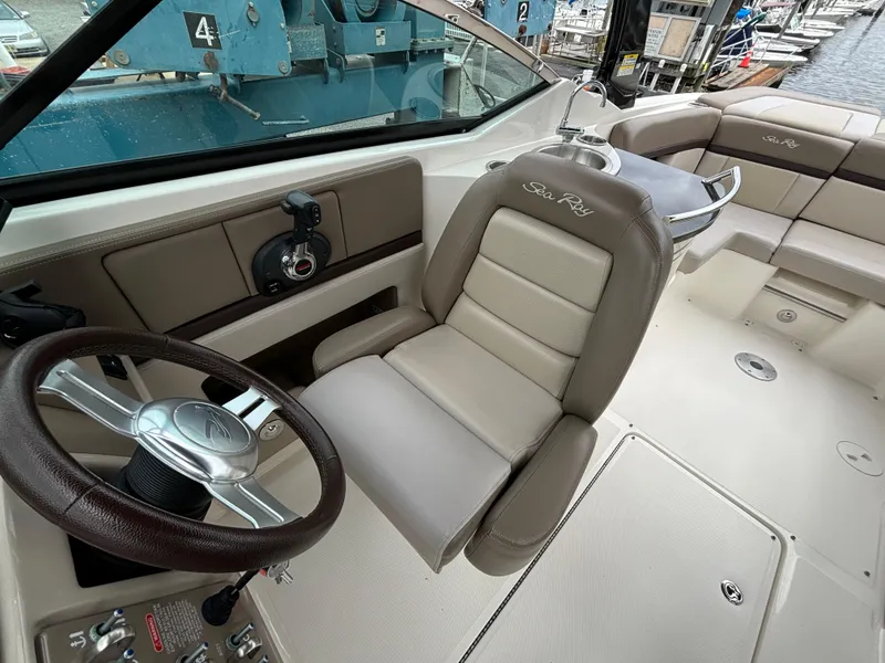 Slide: The Image of 2013 Sea Ray 270 SLX boat interior with steering wheel and seating. - 16