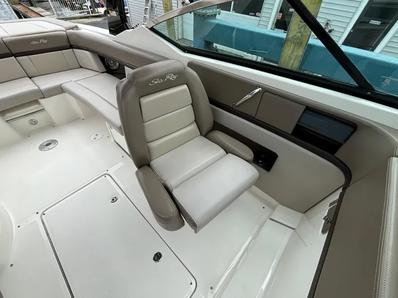 Slide: The Image of 2013 Sea Ray 270 SLX boat interior with beige seating and sleek design. - 18