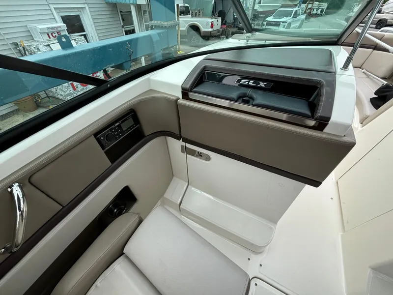 Slide: The Image of Interior view of a 2013 Sea Ray 270 SLX boat, featuring sleek seating and dashboard. - 19
