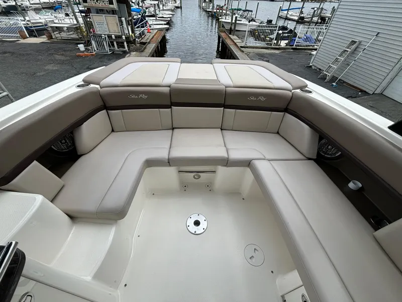 Slide: The Image of 2013 Sea Ray 270 SLX boat interior with spacious seating at a marina. - 22