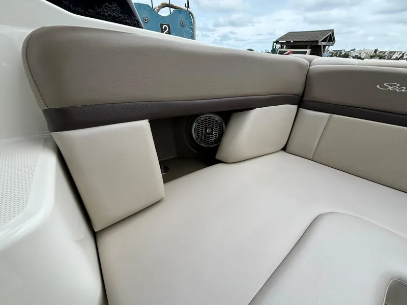Slide: The Image of 2013 Sea Ray 270 SLX boat interior with beige seating and speaker. - 25