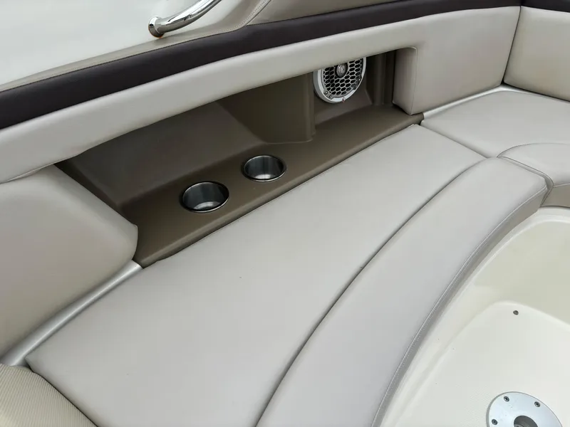 Slide: The Image of 2013 Sea Ray 270 SLX boat interior with beige seating and cup holders. - 26