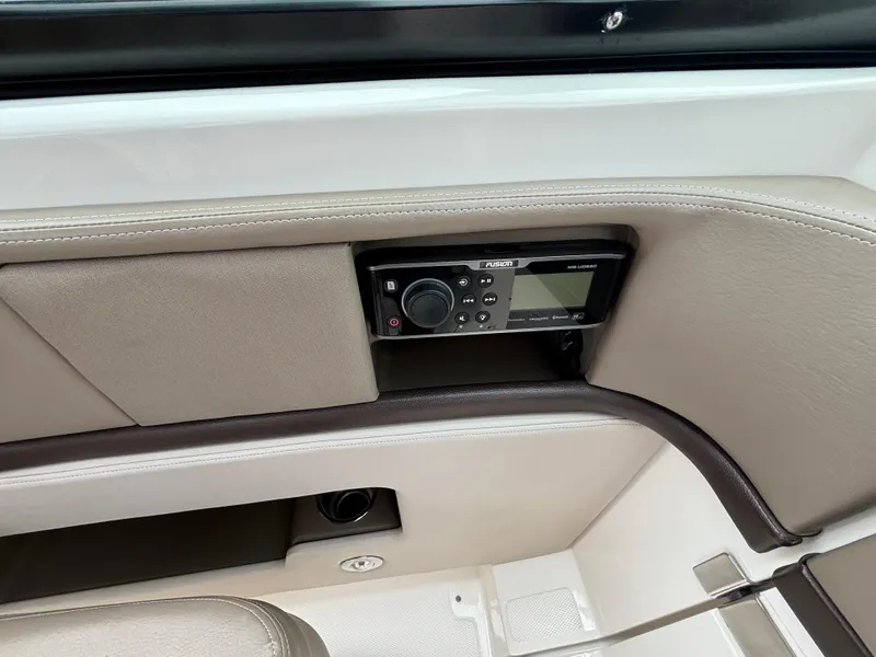 Slide: The Image of 2013 Sea Ray 270 SLX boat interior with control panel and beige upholstery. - 27