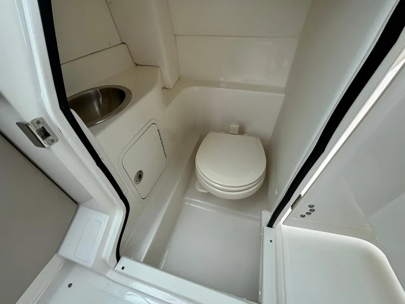 Slide: The Image of 2013 Sea Ray 270 SLX boat bathroom with toilet and sink. - 29
