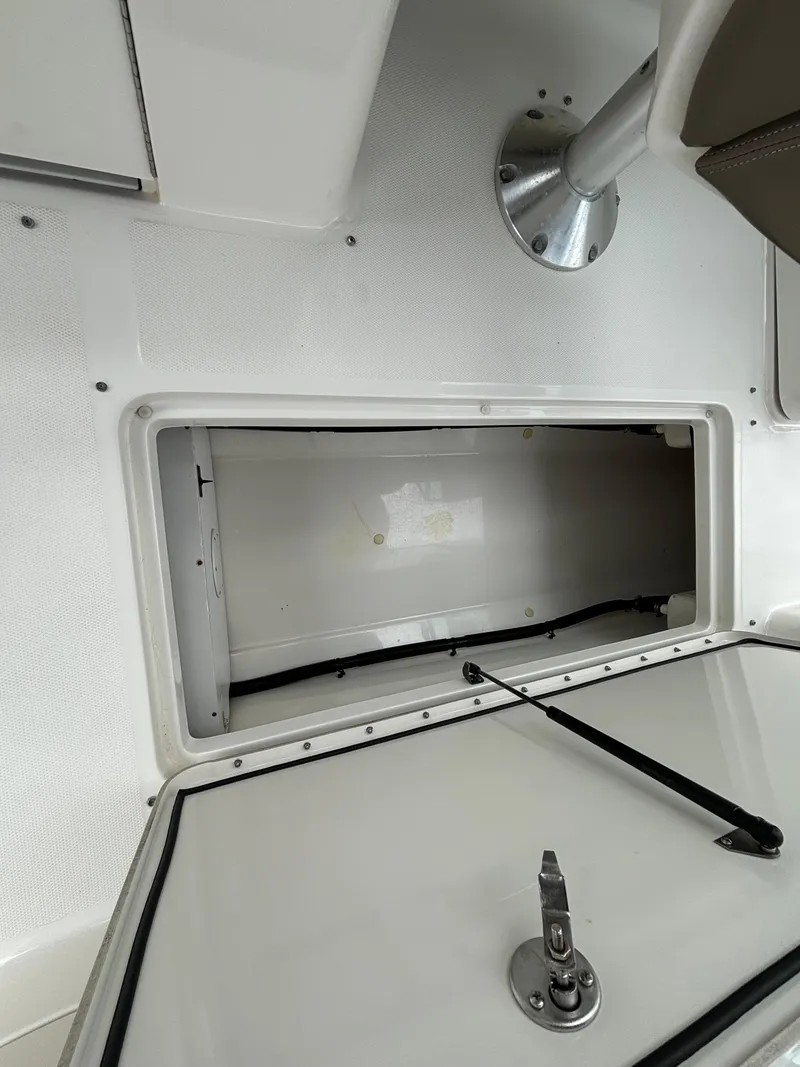 Slide: The Image of Storage compartment of a 2013 Sea Ray 270 SLX boat, open and empty. - 32