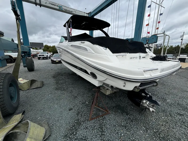 Slide: The Image of 2013 Sea Ray 270 SLX boat on dry dock, covered and ready for maintenance. - 37