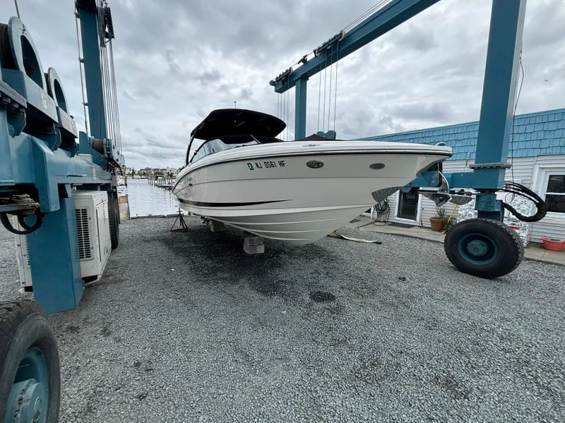 Slide: The Image of 2013 Sea Ray 270 SLX boat on a lift, cloudy sky background. - 39