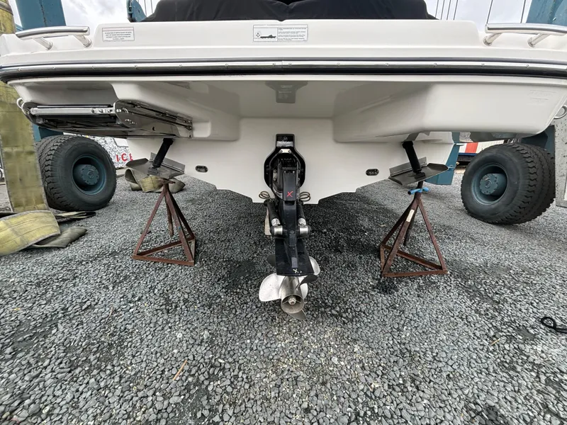 Slide: The Image of 2013 Sea Ray 270 SLX boat on stands, rear view showing propeller and outdrive. - 7