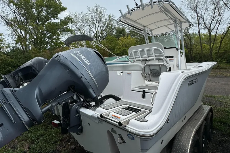 Slide: The Image of 2023 Sea Fox 228 Commander boat with Yamaha engine, parked outdoors. - 10