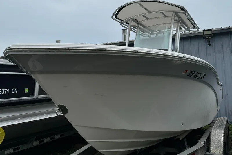 Slide: The Image of 2023 Sea Fox 228 Commander boat with sleek design and T-top canopy. - 2