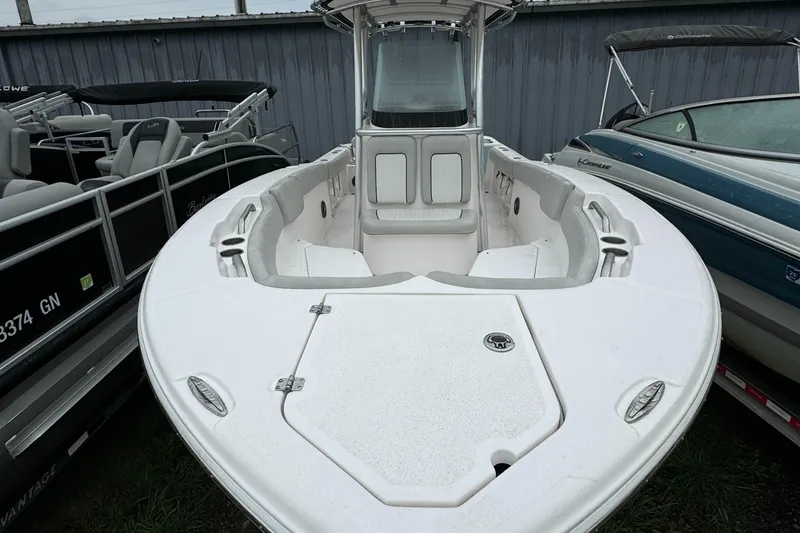 Slide: The Image of 2023 Sea Fox 228 Commander boat, white deck, docked between other boats. - 5