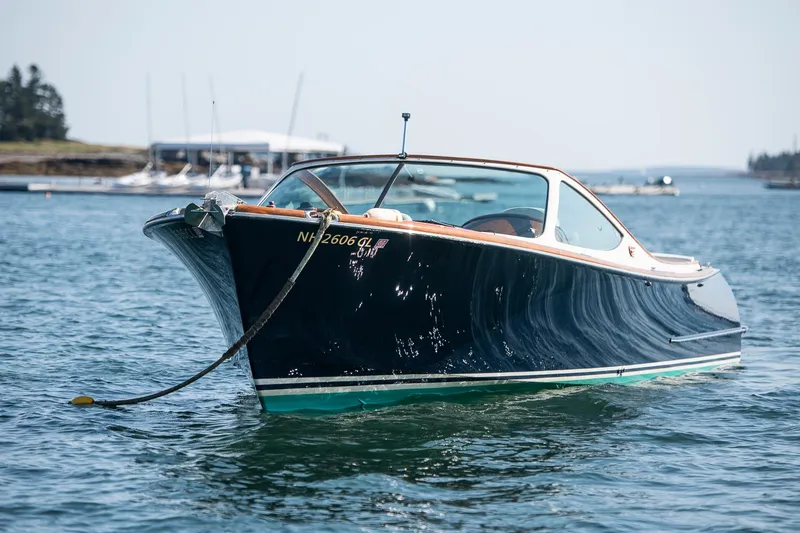 Slide: The Image of 2004 Hinckley Talaria 29 Runabout on calm water, showcasing sleek design and elegance. - 0