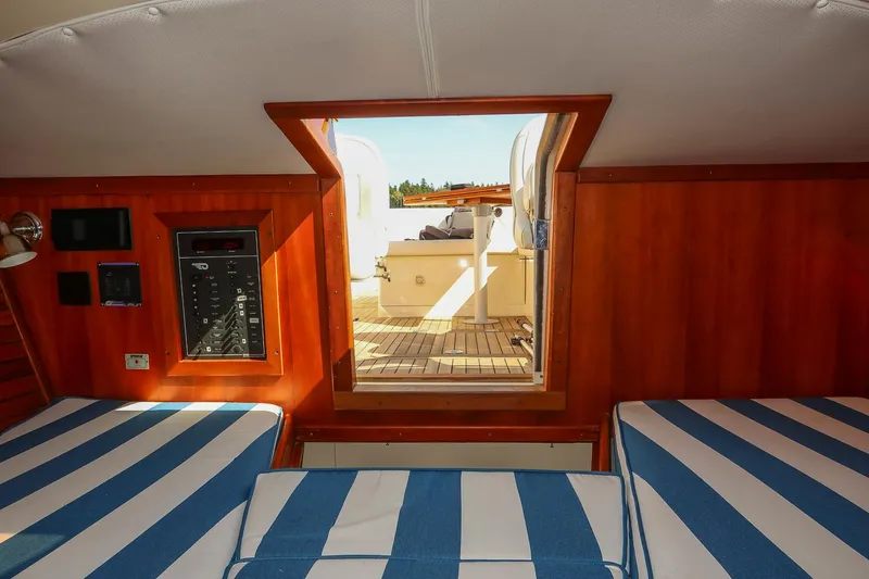 Slide: The Image of Interior of 2004 Hinckley Talaria 29 Runabout with striped seating and wooden paneling. - 24