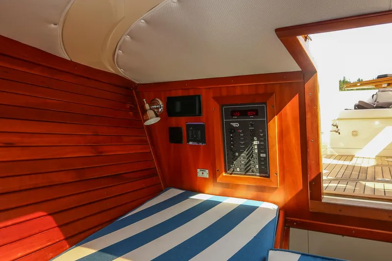 Slide: The Image of Interior of 2004 Hinckley Talaria 29 Runabout with striped seating and wooden paneling. - 25