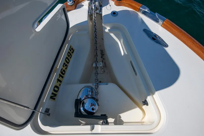 Slide: The Image of Anchor compartment of 2004 Hinckley Talaria 29 Runabout with visible chain and winch. - 30