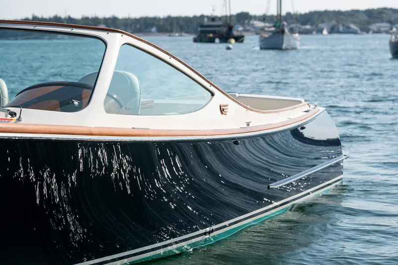 Slide: The Image of 2004 Hinckley Talaria 29 Runabout on calm water, showcasing sleek design and craftsmanship. - 33