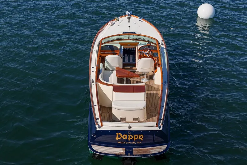 Slide: The Image of 2004 Hinckley Talaria 29 Runabout on water, featuring elegant design and luxurious seating. - 6