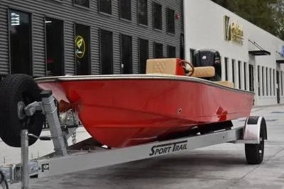 Slide: The Image of Red 2023 ZCB Curlew 18 boat on trailer outside a building. - 1