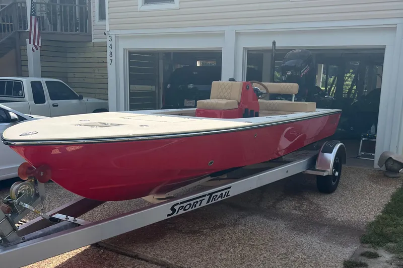 Slide: The Image of Red 2023 ZCB Curlew 18 boat on Sport Trail trailer in driveway. - 11
