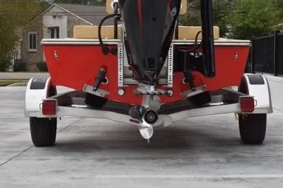 Slide: The Image of 2023 ZCB Curlew 18 boat on trailer, rear view, red hull, outboard motor. - 2