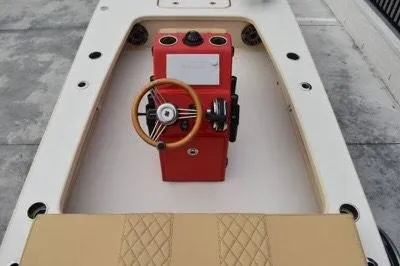 Slide: The Image of 2023 ZCB Curlew 18 boat interior with red console and tan seating. - 7